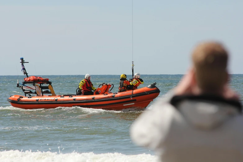 a boat filled with people being pulled by a raft