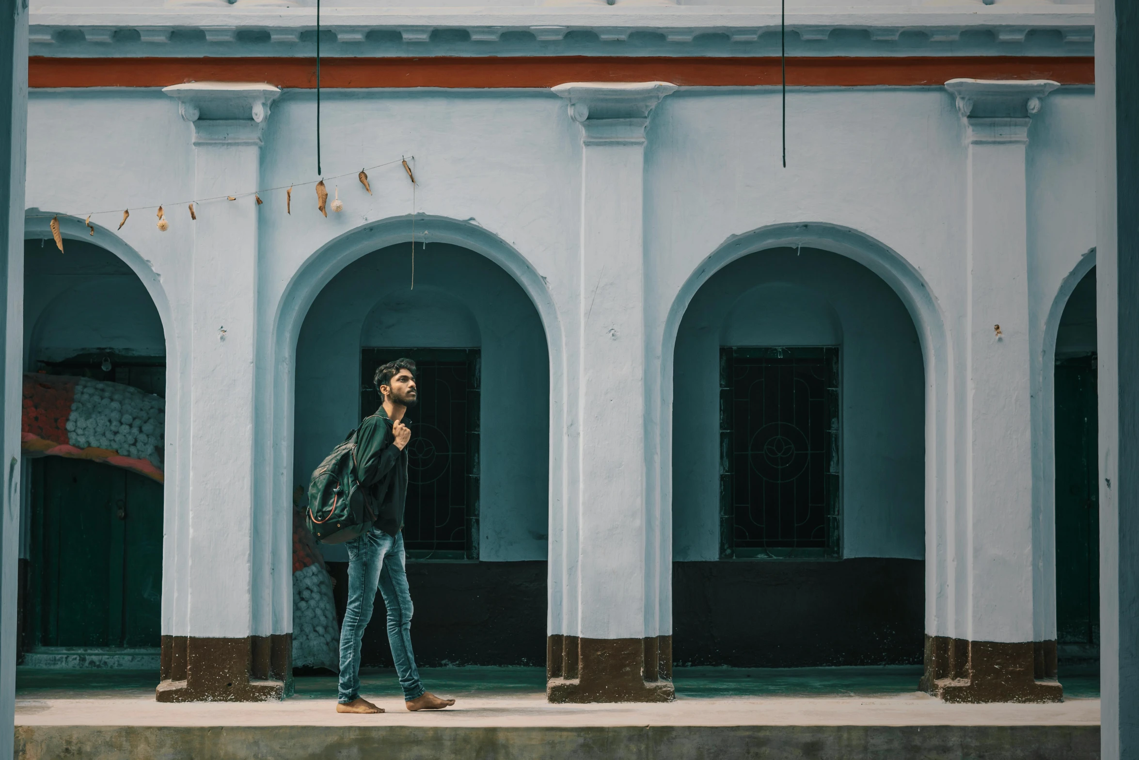 a man standing in front of a white building