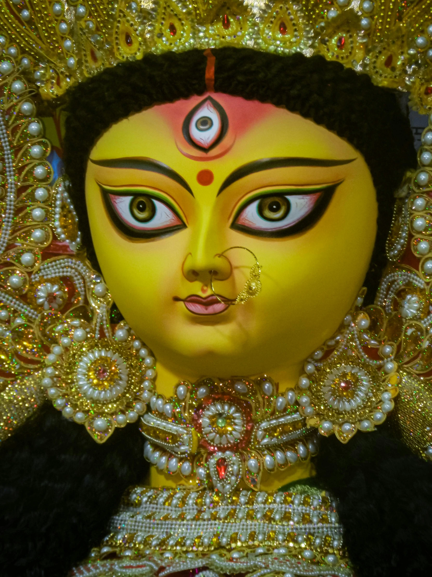 closeup of a colorful face with a headpiece