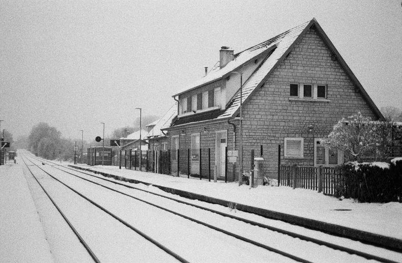 a building and rail tracks covered in snow