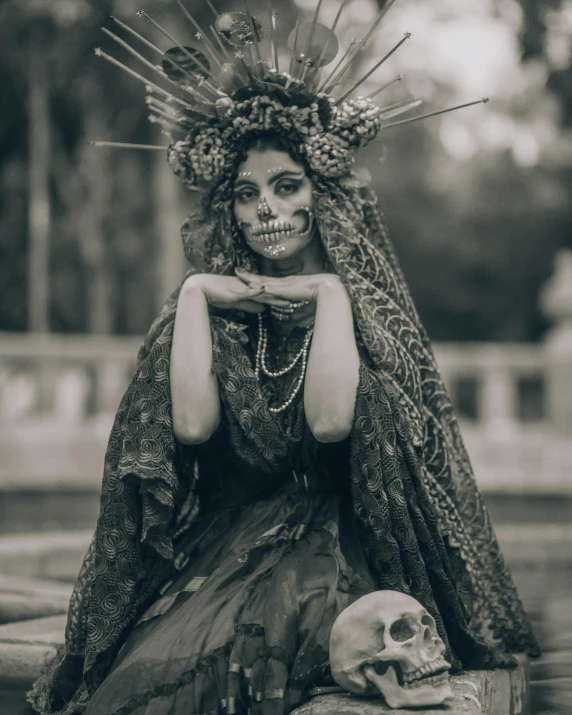 a woman with a skeleton and crown is sitting on a table