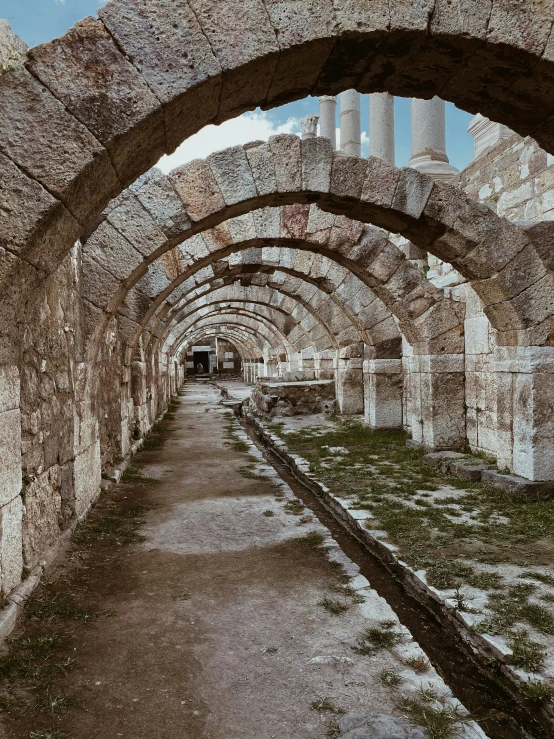 an abandoned city tunnel surrounded by concrete pillars