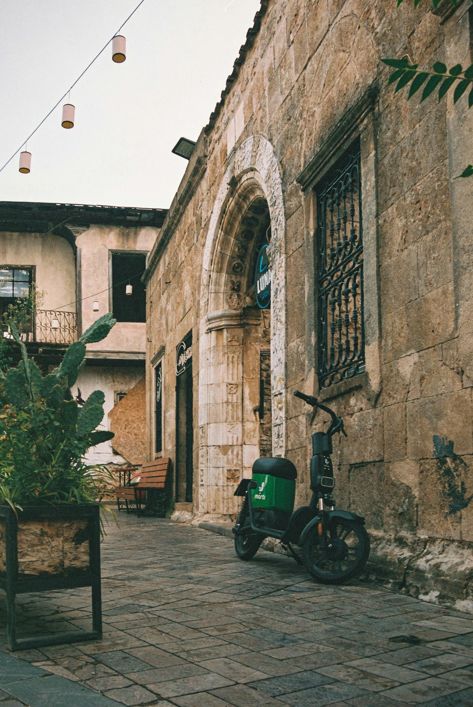 an old alley with a motorbike parked near a window