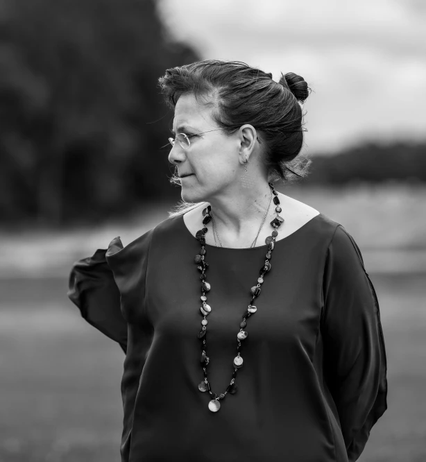 a woman that has beads on her necklace