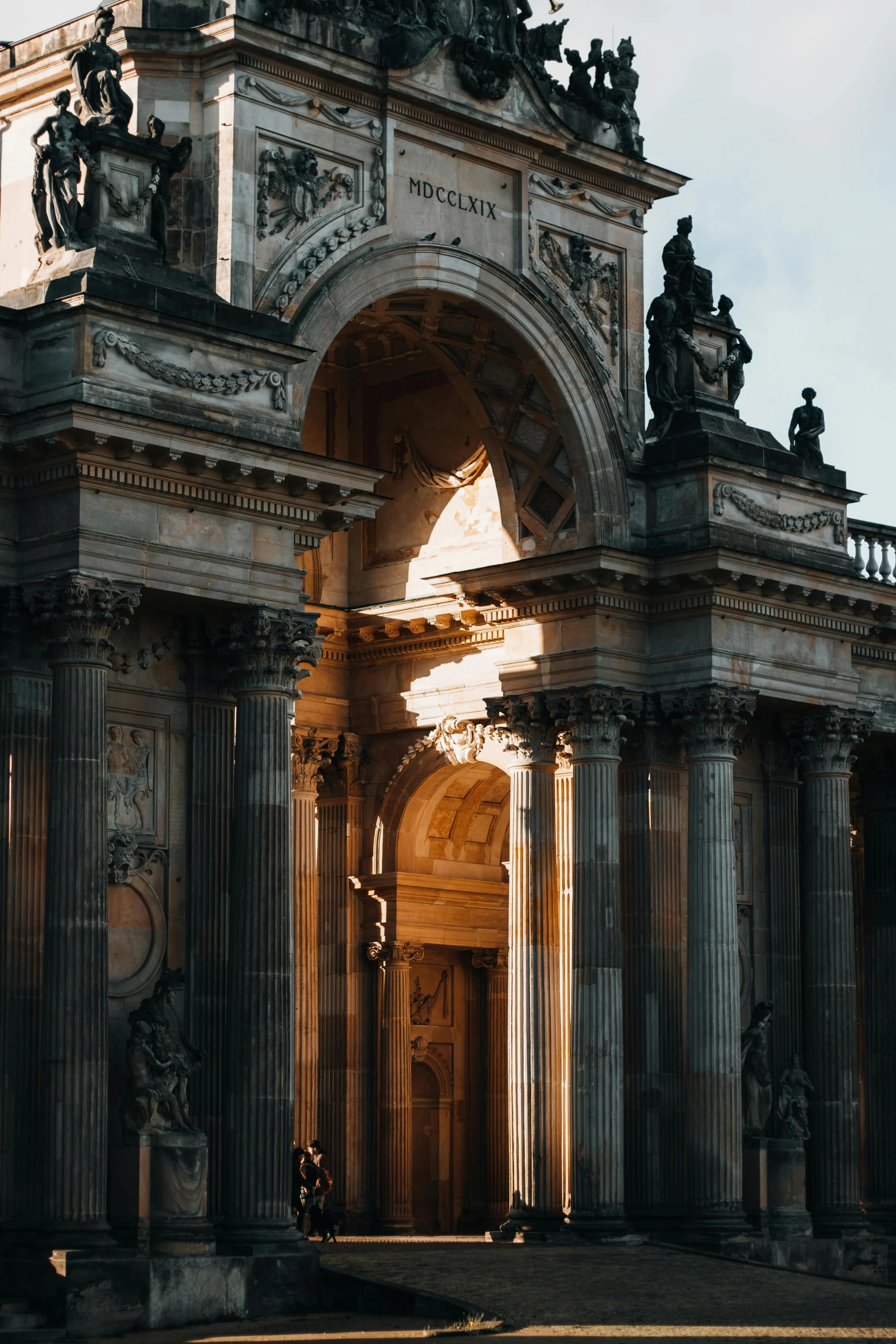 an archway leading up to a domed building