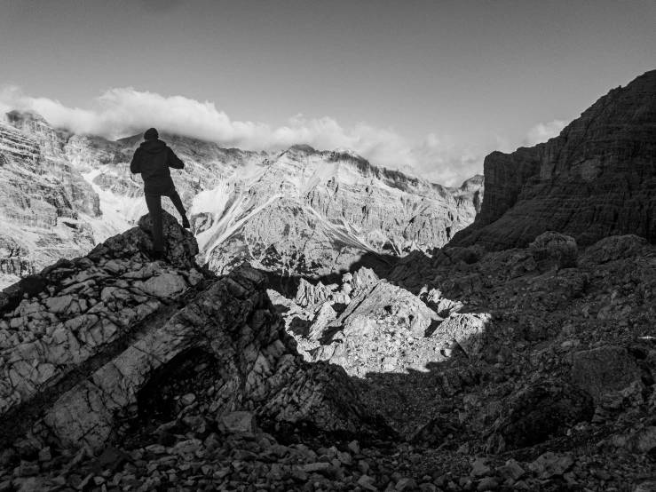 a person standing on a mountain top looking out at the mountains