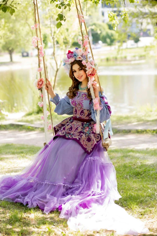 a woman with a dress is on a swing