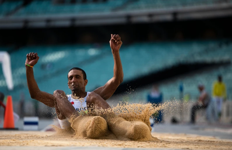 a man slides over the ground on a beach