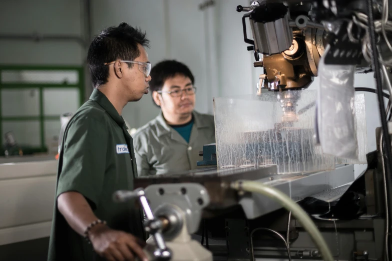 two workers are working on machine tools in the factory