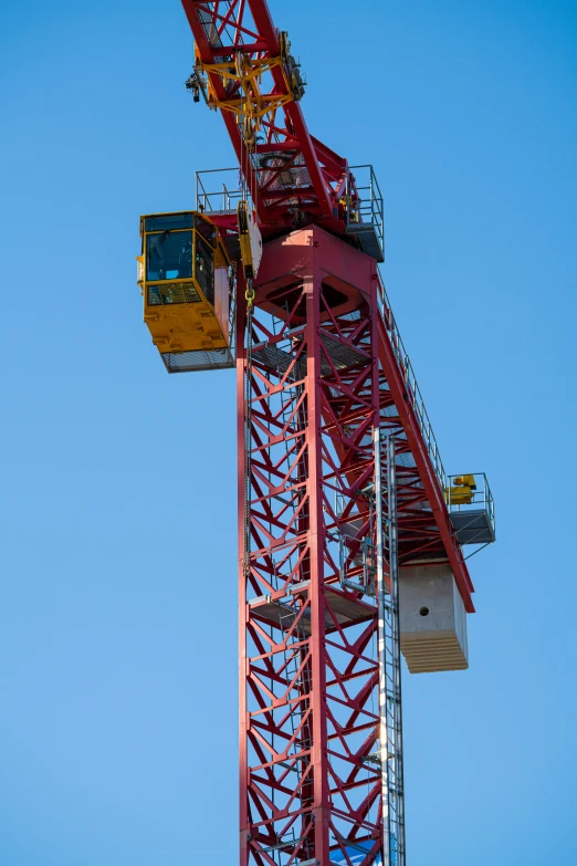 a large crane is against the blue sky