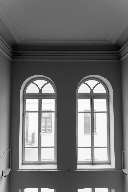 an old room has two arched windows