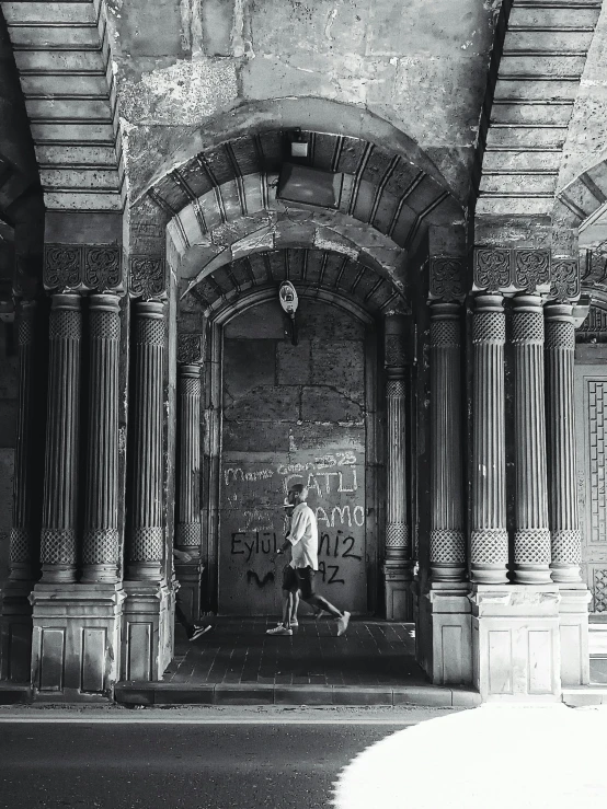 an arch on the outside of a building is covered with graffiti