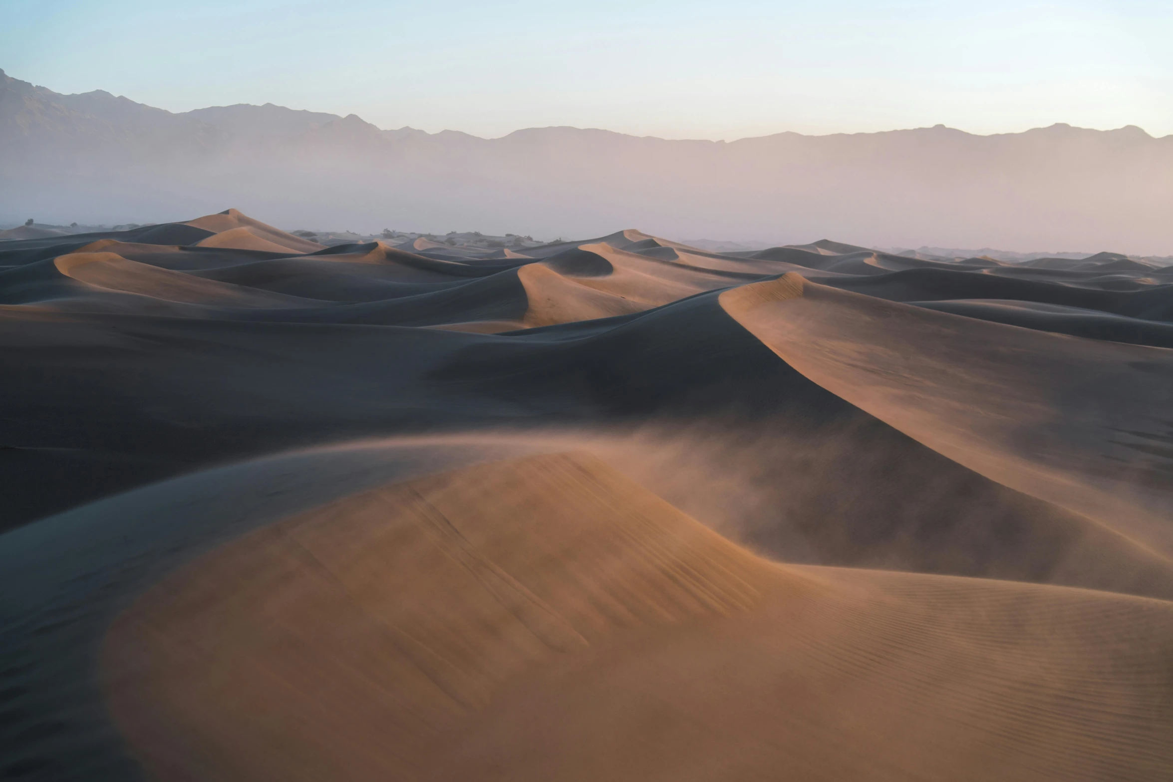 a desert landscape is covered with sand dunes