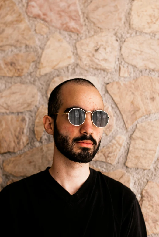 a man in black shirt wearing sunglasses with head cut