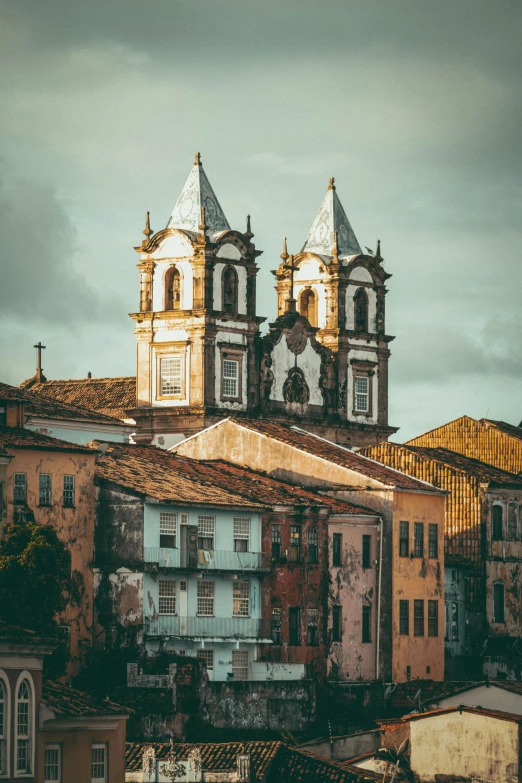 large old buildings sit behind an old church