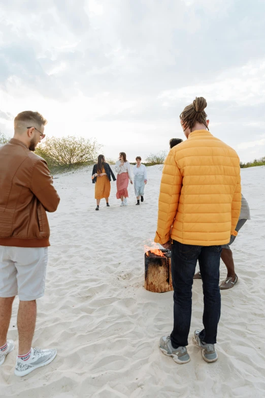 the people are walking in the sand together