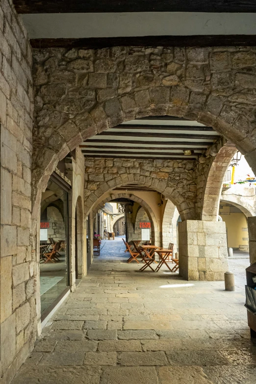 an archway and table in an arched stone building