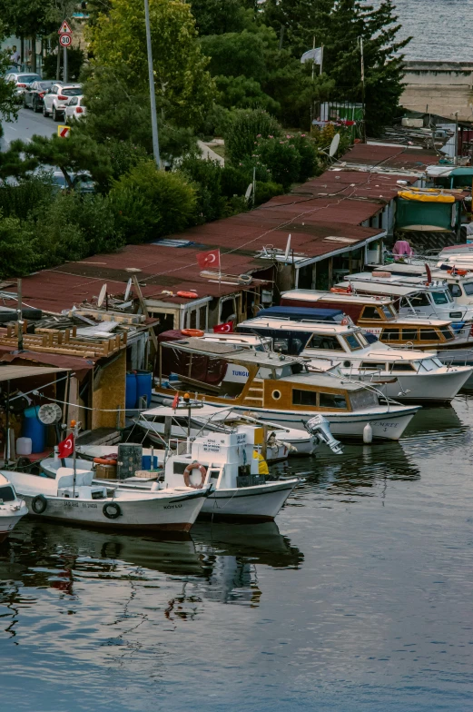 several boats are docked in the bay near a building