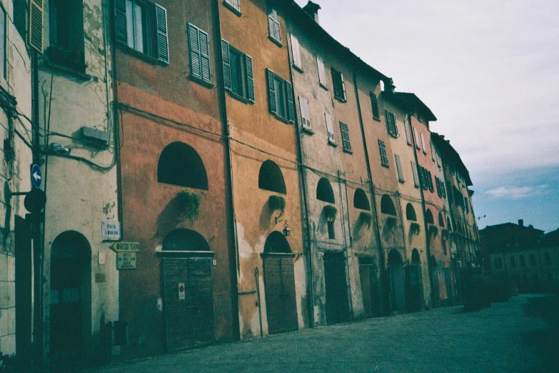 an old building with arches, windows and a clock on it