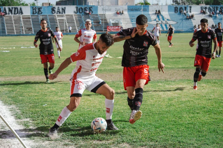 a team of soccer players in action on the field