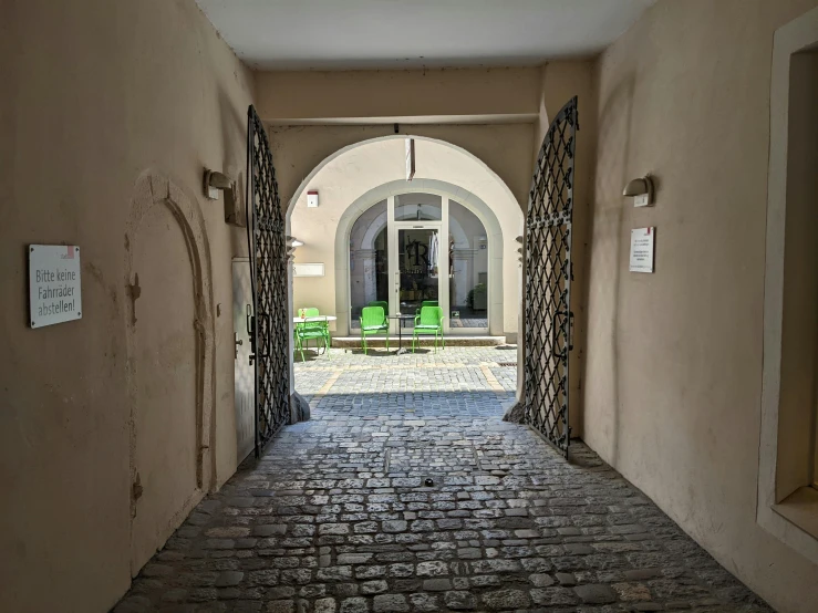 a brick walkway is through a doorway in a building