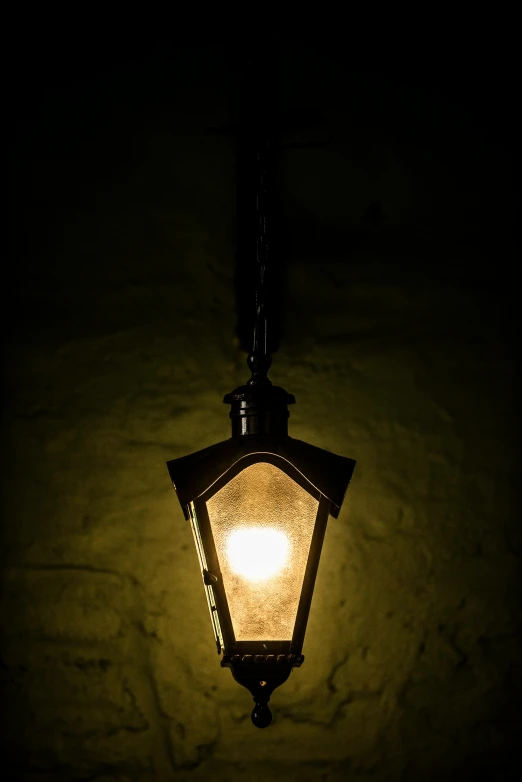 a glowing lamp on the outside of a house