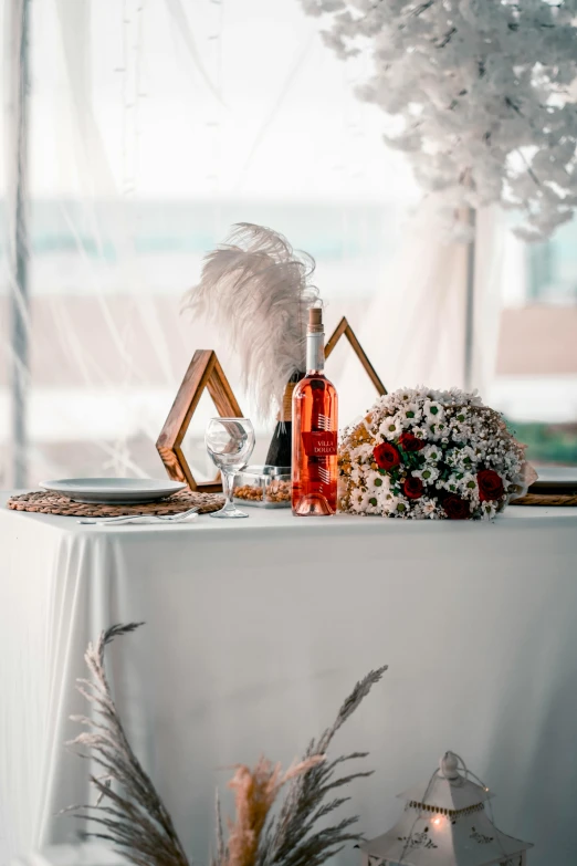 wedding table set up with flowers, wine glasses and other items