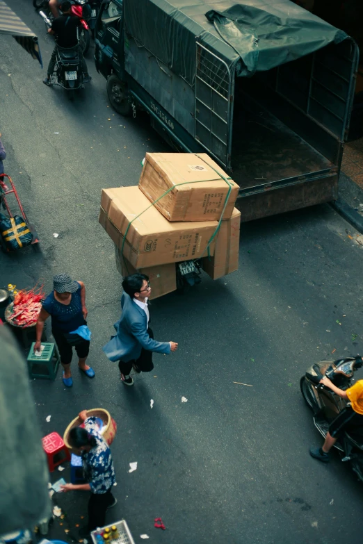 people and vehicles moving supplies from truck to truck