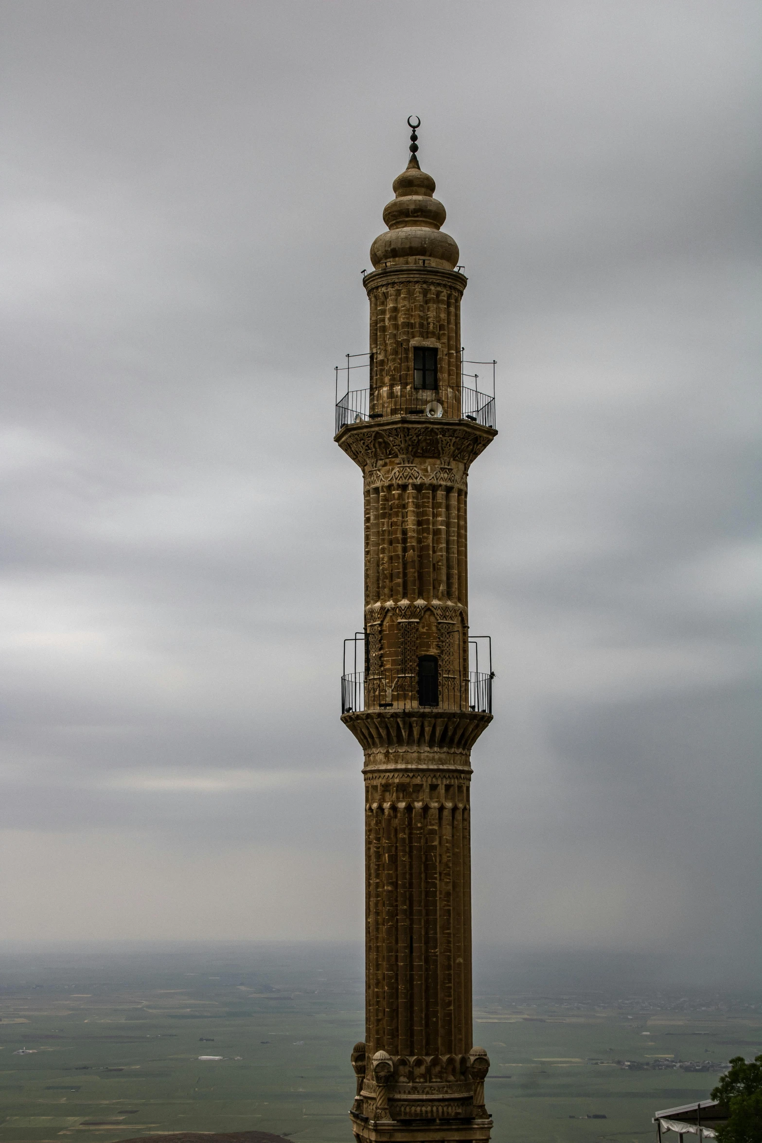 a tower with clock at the top is high in the sky