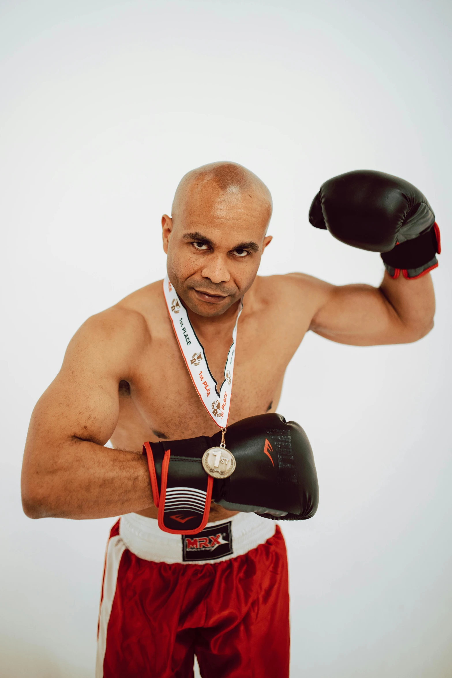 a boxer with a boxing glove, medal and medal around his neck