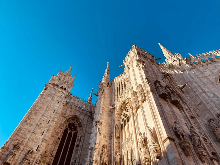 a very tall gothic building sitting below a blue sky