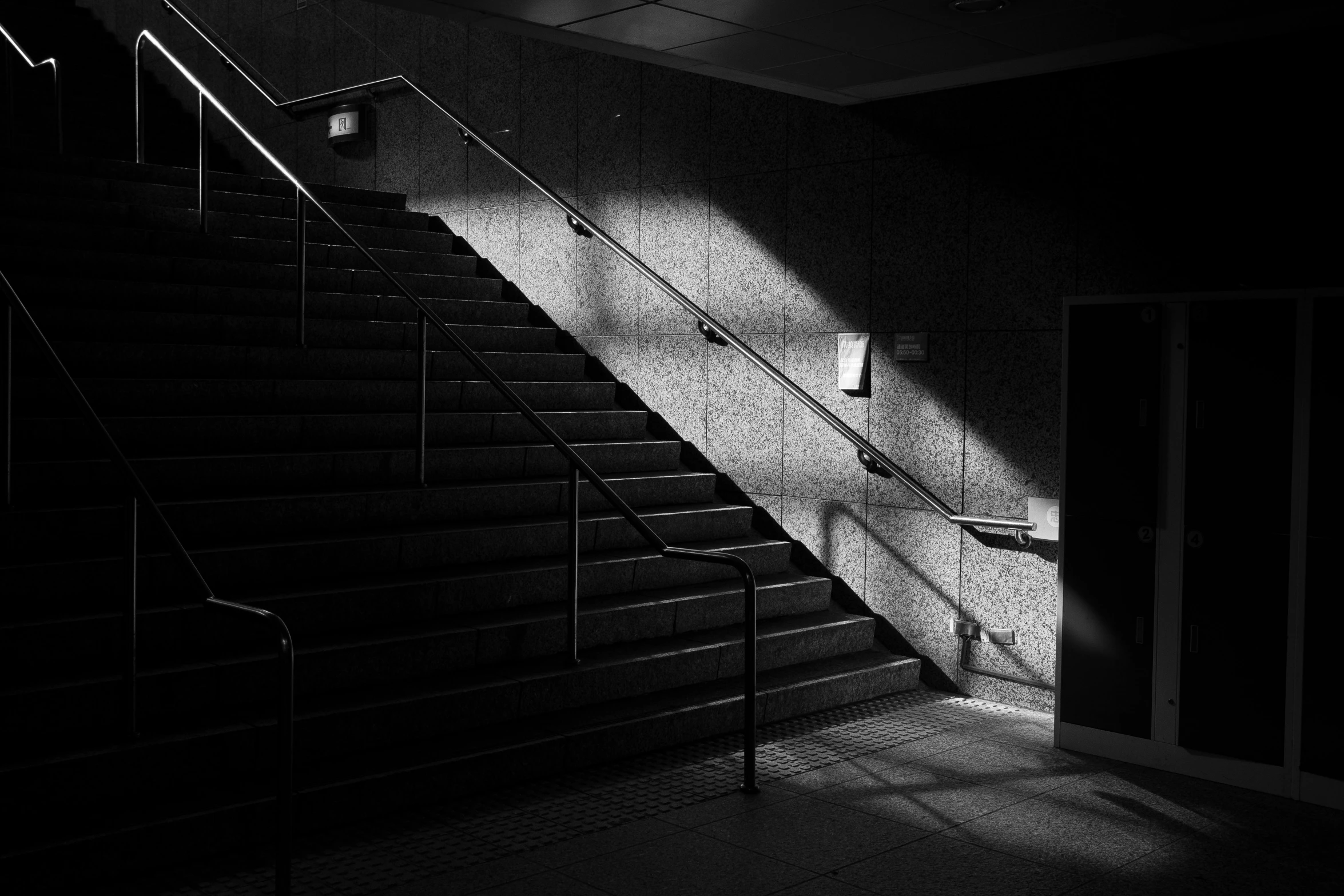 there is light coming through the door onto a set of stairs