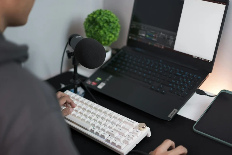 a person using a keyboard to type on a laptop