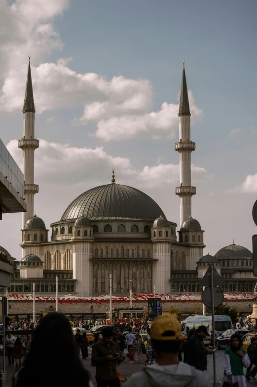 the large white building has two pointed towers