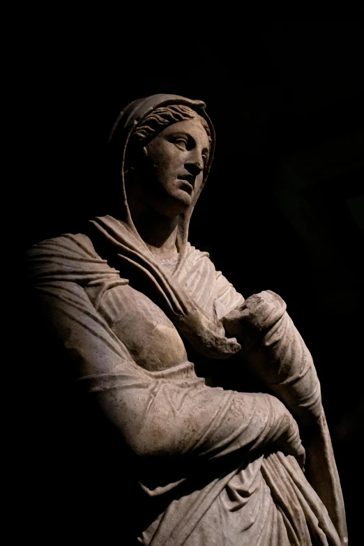a statue is shown against a dark background