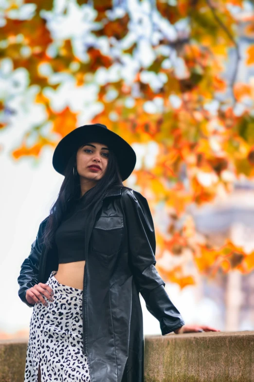 a woman in a long skirt and black coat