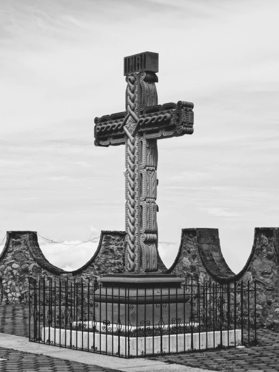 the cross is surrounded by decorative brick and stonework