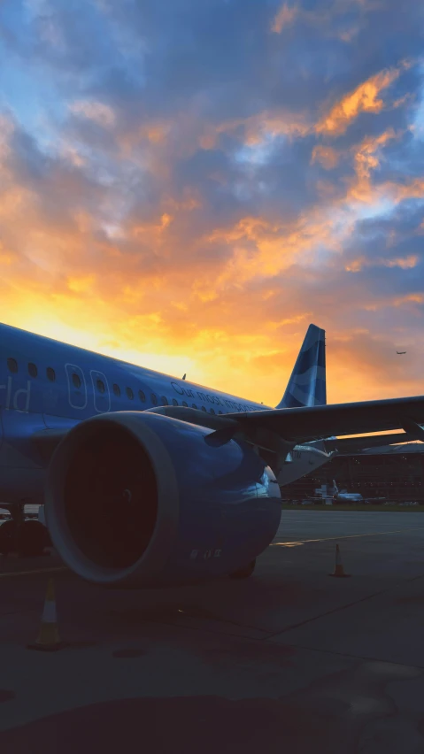 a plane is parked at the airport in the evening