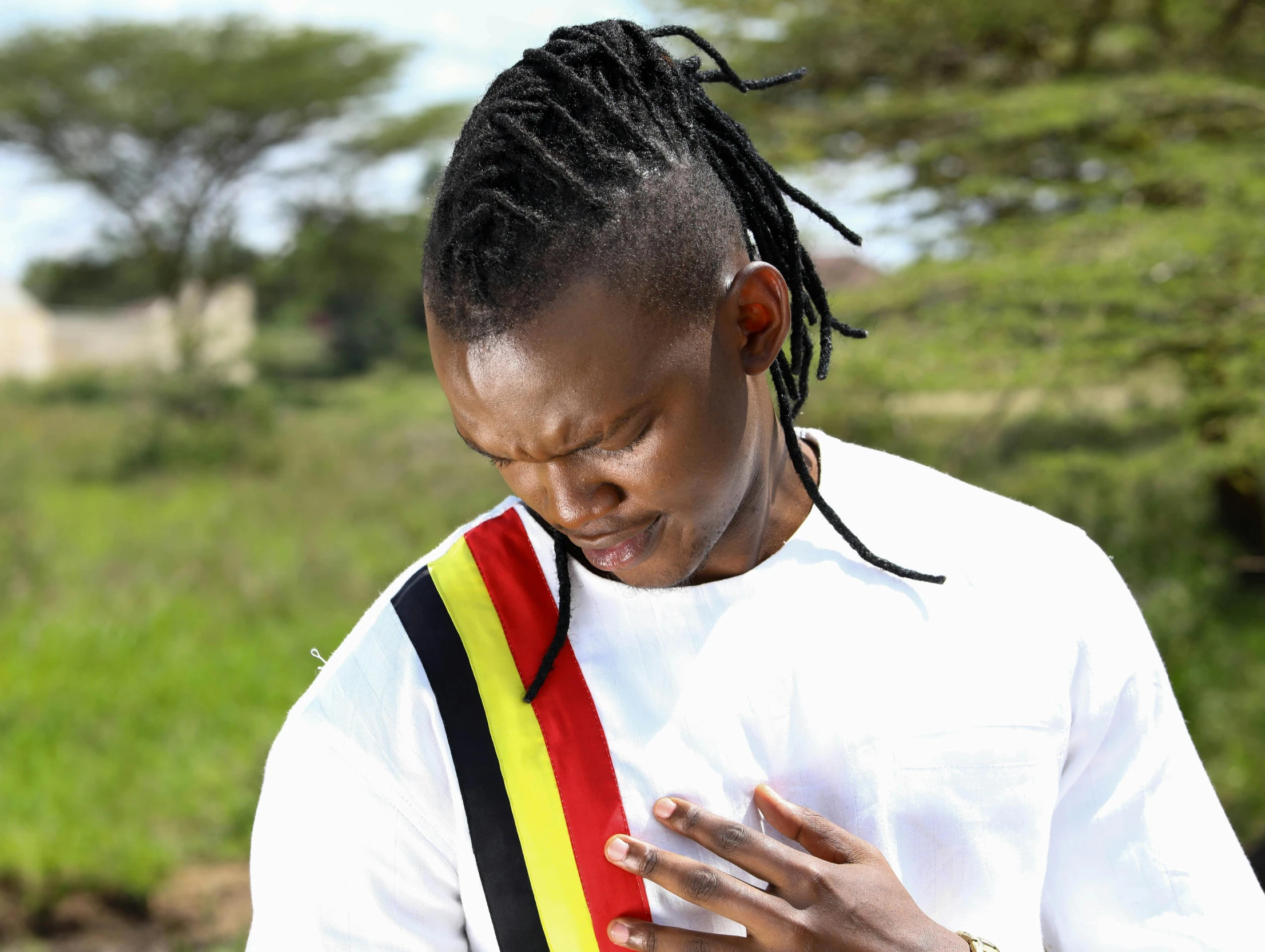 a woman in a white shirt with her hands folded