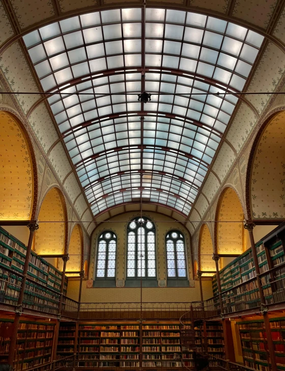 a large liry with a glass roof, and bookshelves