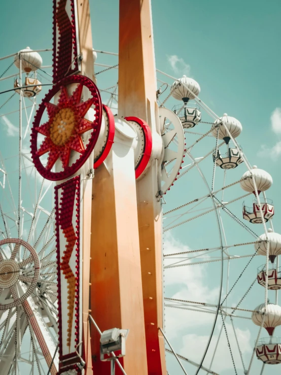 ferris wheel with other rides against a blue sky