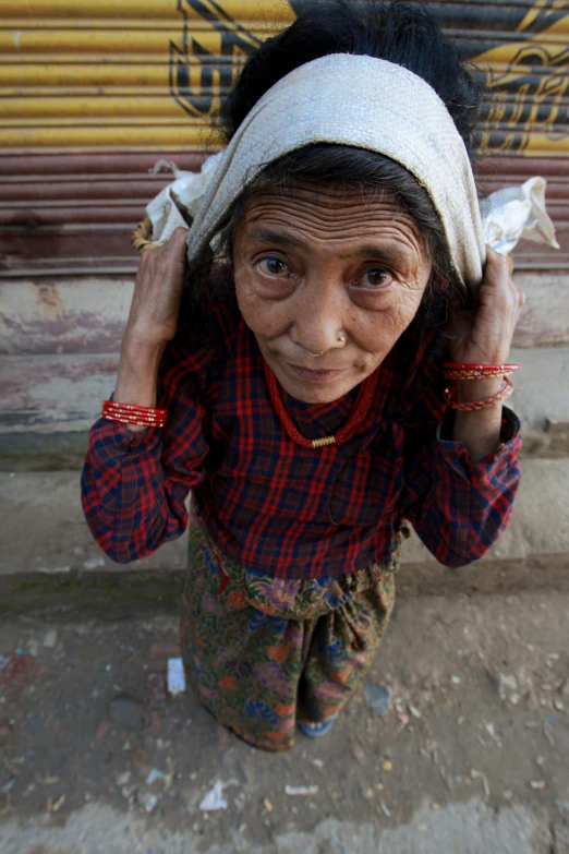 a woman with a white head covering on her ear