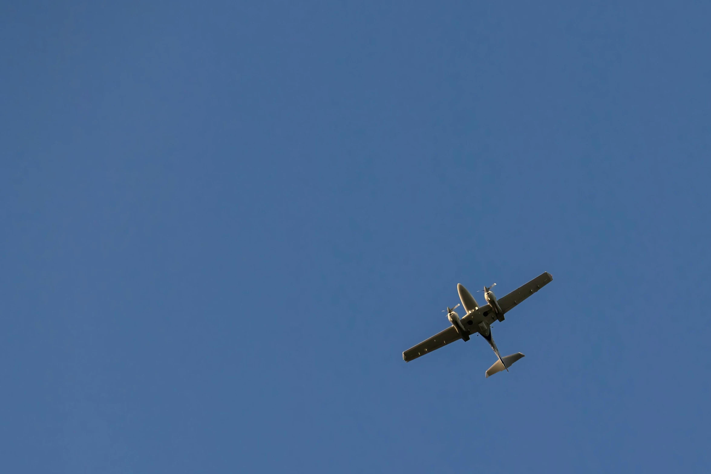 an old plane is flying through the sky