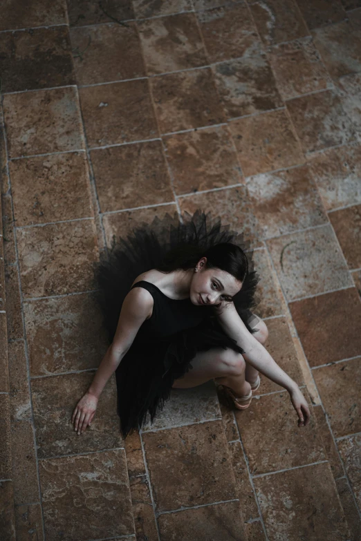 woman lying on the floor with her hands on her hair