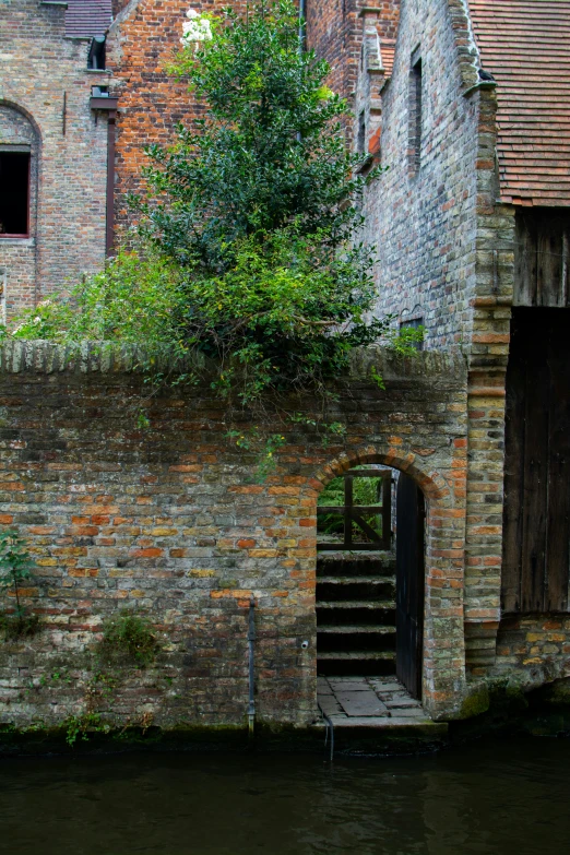 a narrow brick staircase going to the top of an old building