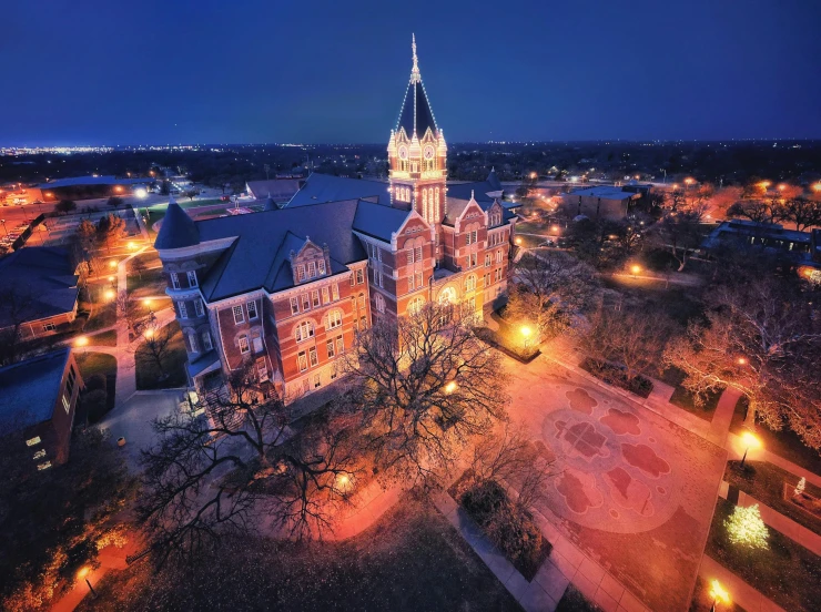 city buildings are lit up with bright lights at dusk