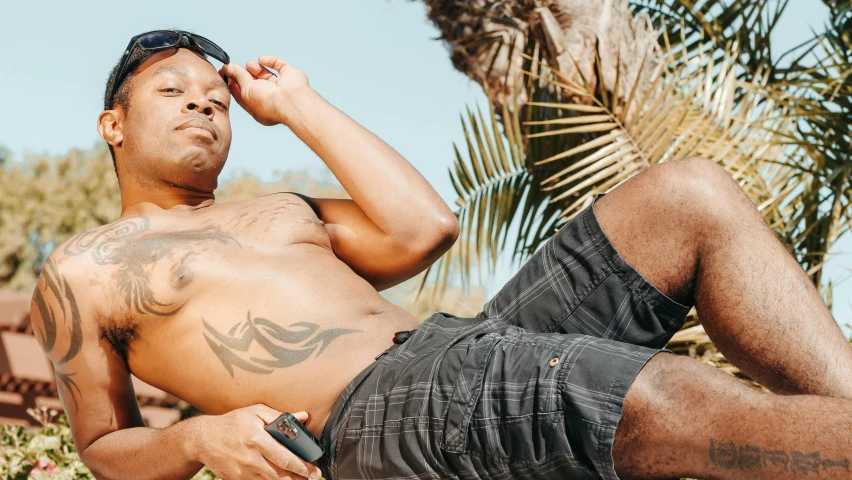 a man lying on top of a sandy beach