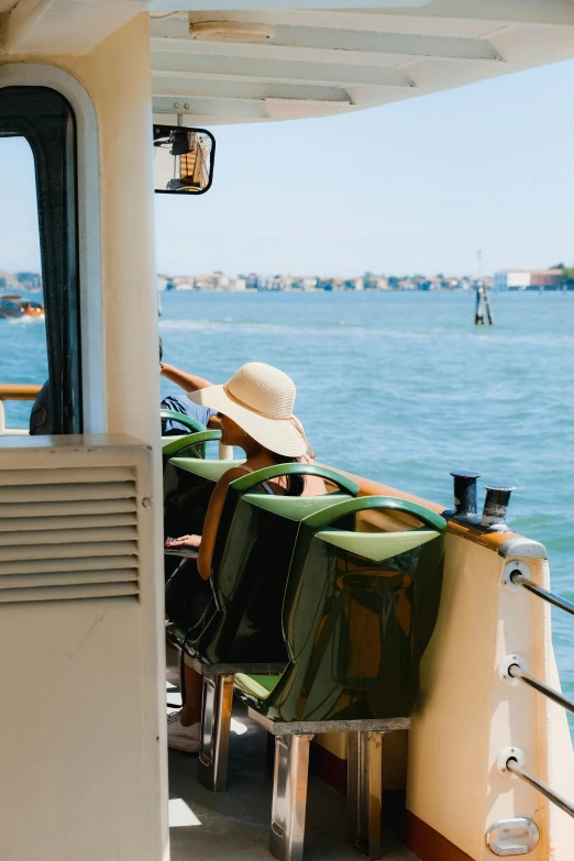 a woman sitting on a boat at sea