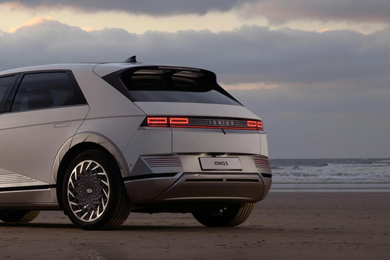 a large car parked on top of a sandy beach