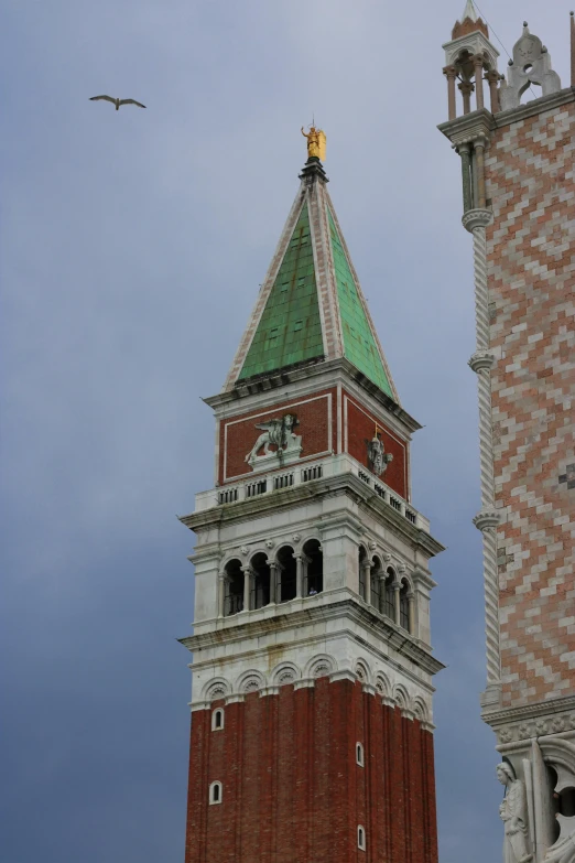 a tall clock tower with a white and green roof